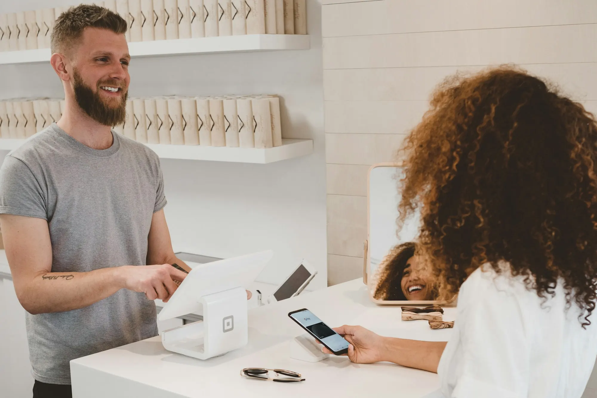 A customer paying by card at a shop counter